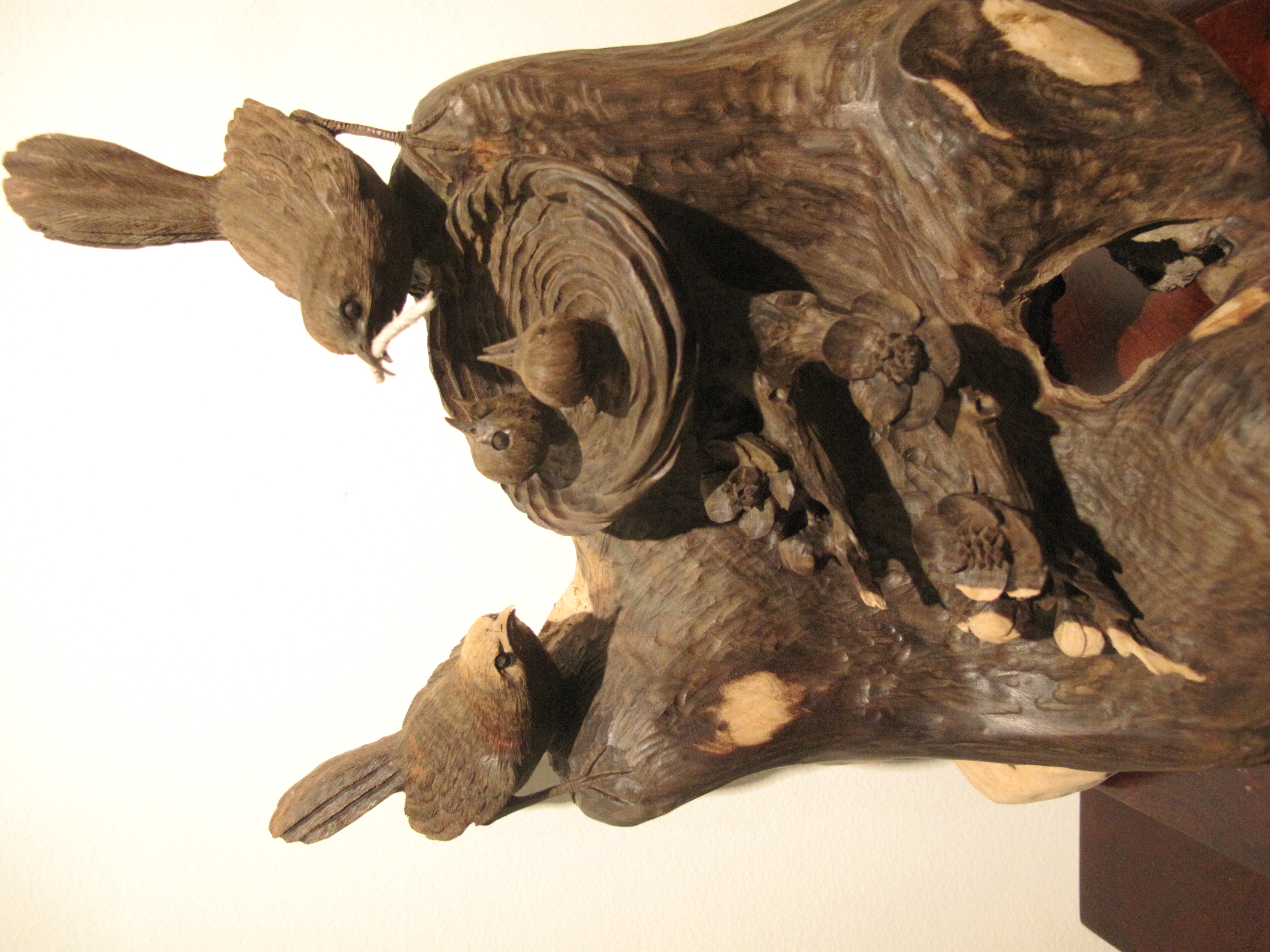 Master artisans carving natural wood sculptures